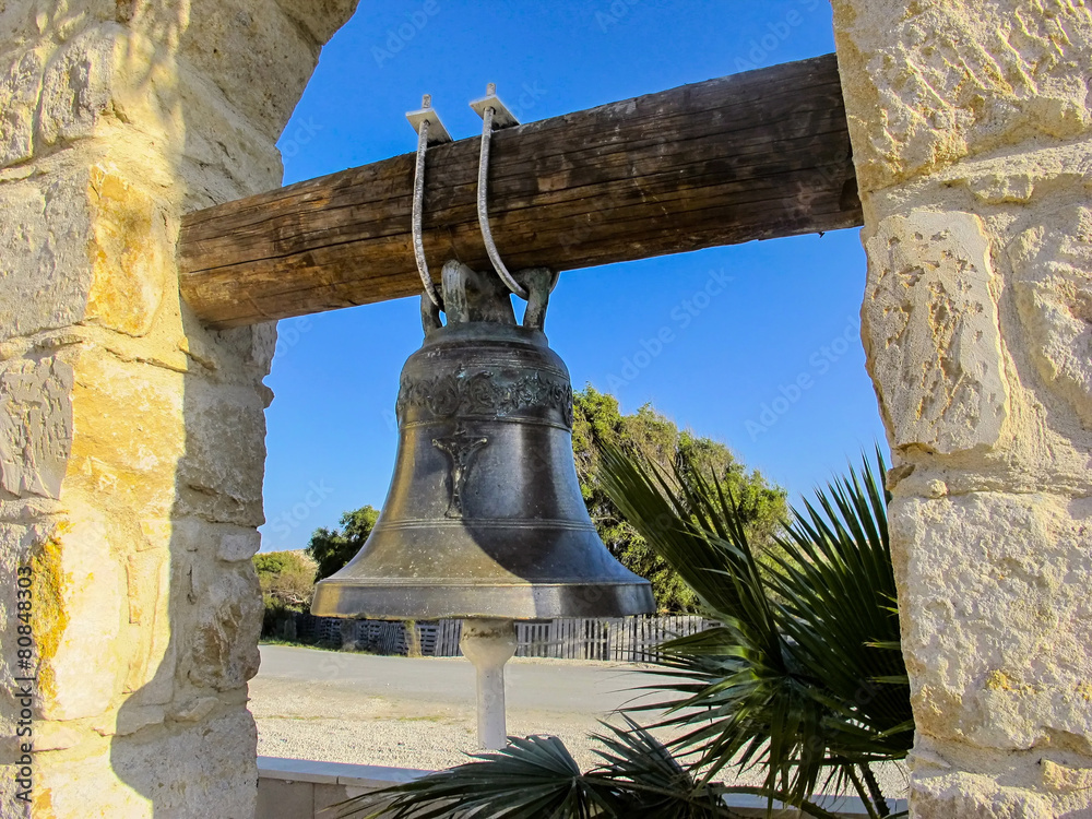 Obraz premium brass bell in the courtyard of the church, cyprus