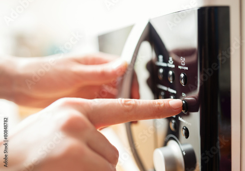 Using microwave oven, close up photo, shallow dof