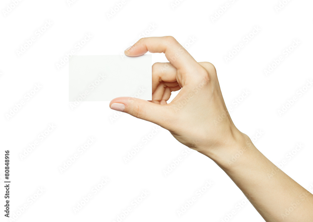 Obraz premium Female hand holding a blank business card, isolated on white