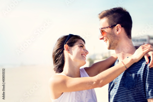 couple in love hugging affectionately in front of the sea
