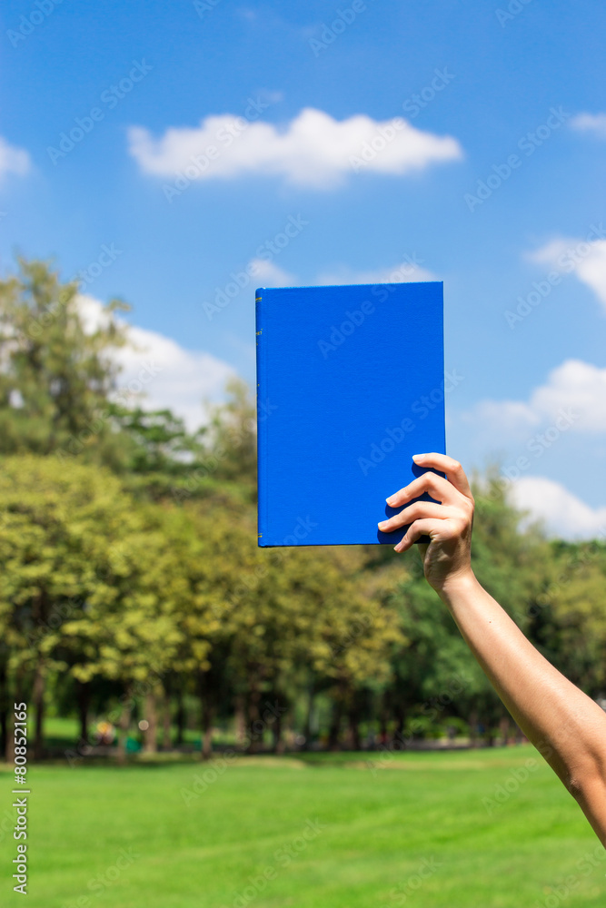 book holded by hand in the sky book holded by hand in the sky
