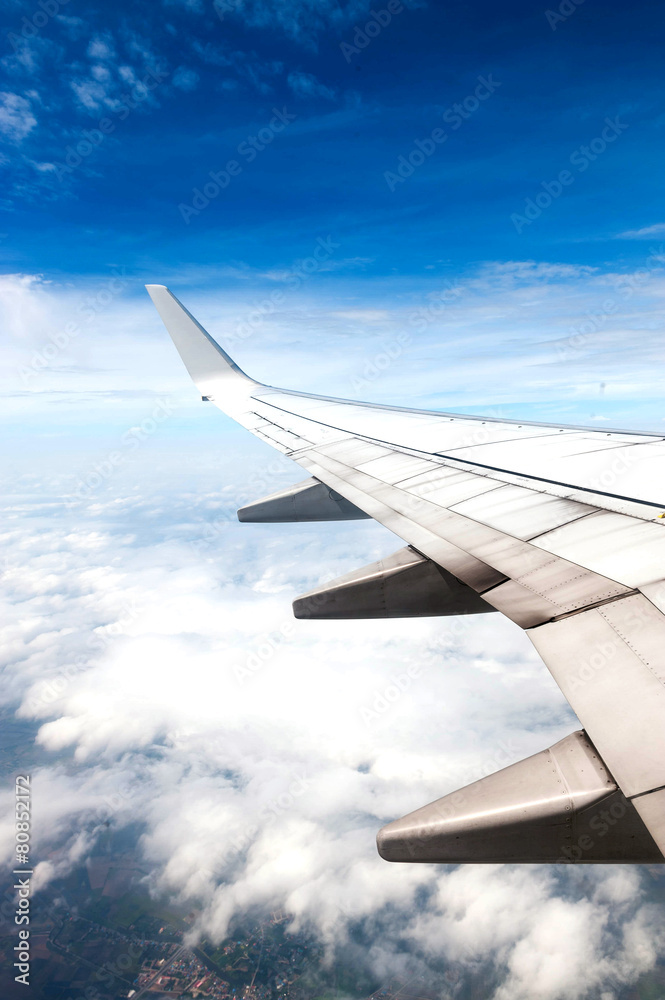 Obraz premium Cloudscape. Blue sky and white cloud. Sunny day. Wing of aircraft.