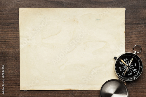 compass and old paper on the brown wooden table