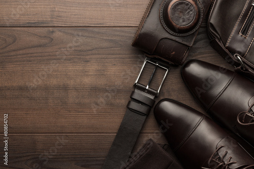 brown shoes, belt, socks and film camera
