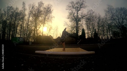 Young man dancing breakdances on the street. photo