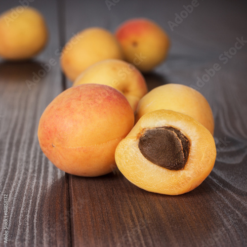 some fresh apricots over wooden background