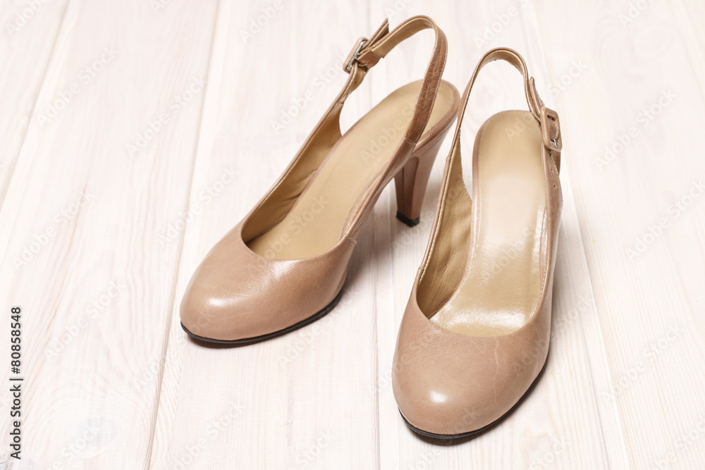 Beige stilettos on white wood Beige stilettos on white wood