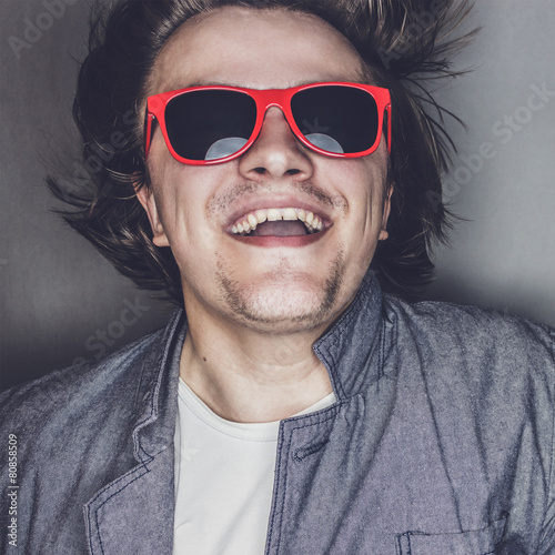 closeup portrait of a casual young man with sunglasses