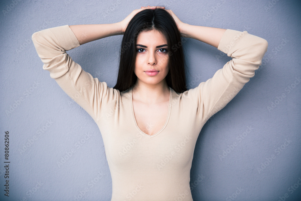 Portrait of a charming young woman over gray background Portrait of a charming young woman over gray background