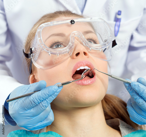 Tooth decay. Dental implants. Young woman visiting dentist