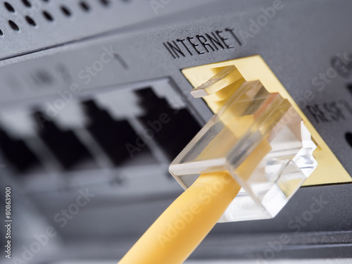Network yellow cable connected to a router or modem