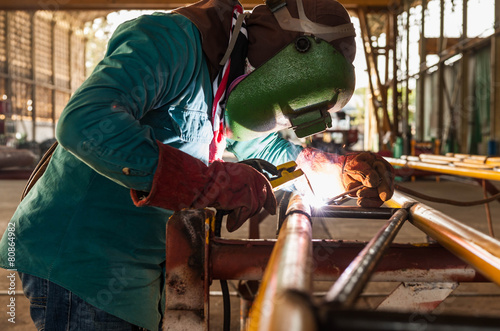 Worker welding the steel structure © arhendrix