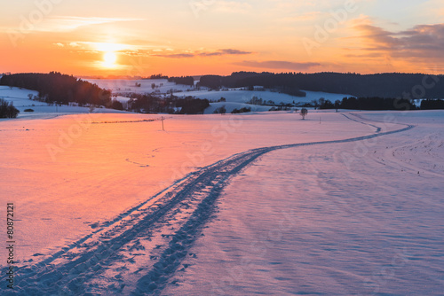 Scene with trail on snow at sunset background photo