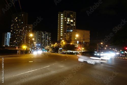 Cars race along Kapiolani Boulevard at Night photo