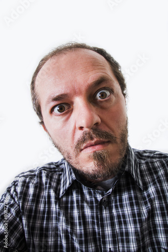 Surprised man in plaid shirt, eyes wide open