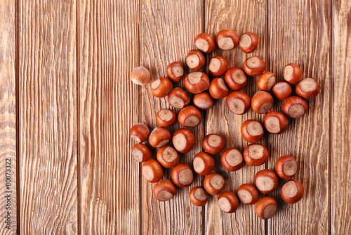 hazelnuts on the brown wooden table background