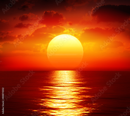 sunset over calm sea © Romolo Tavani