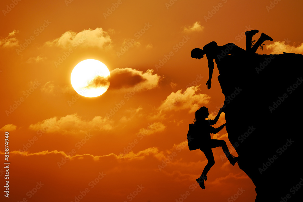 teamwork of two people man and girl travelers help on mountain teamwork of two people man and girl travelers help on mountain