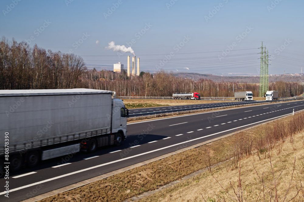 Tanker and truck enters the highway with moving trucks