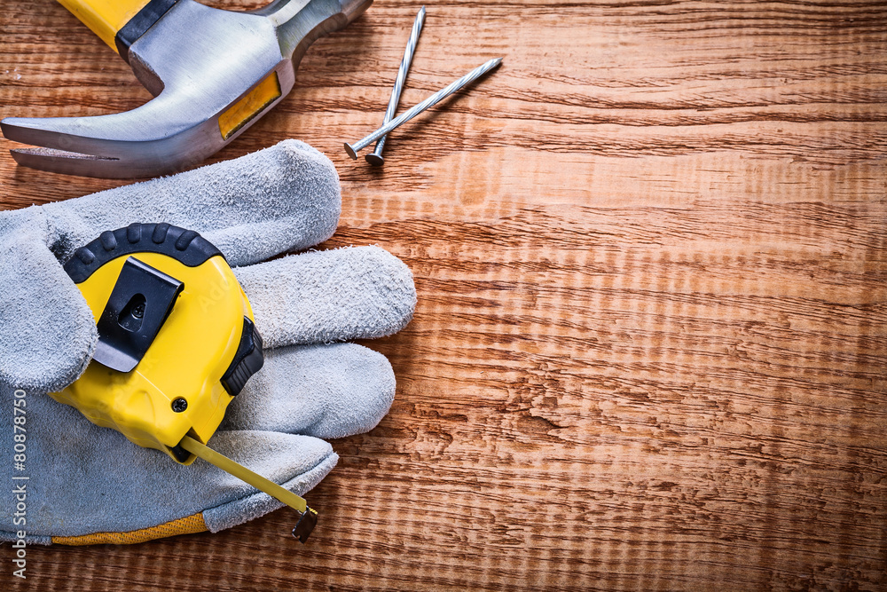 yellow roulette in protective glove hammer nails on vintage wood