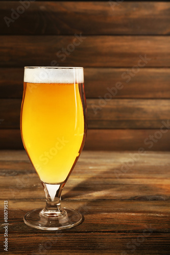 Glass of beer on wooden background