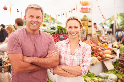 Couple Running Stall At Farmers Fresh Food Market