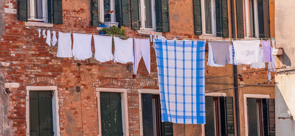 Fototapeta premium Venetian windows with the laundry drying on a wire