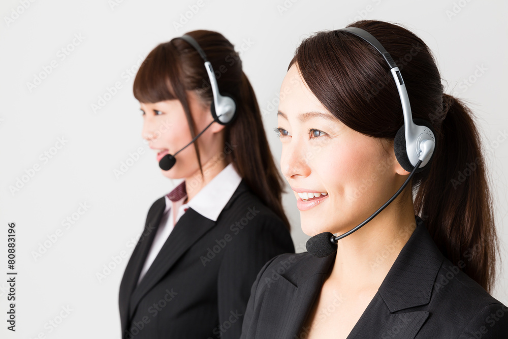 asian businesswomen using headset asian businesswomen using headset