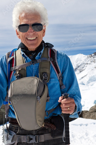 Billede på lærred Active senior man hiking in the snowy mountains