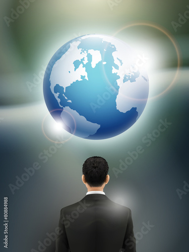 businessman looking at realistic earth graphic
