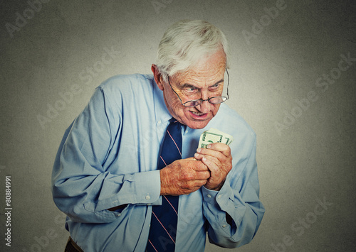 greedy executive, CEO, boss mature man holding dollar banknotes photo