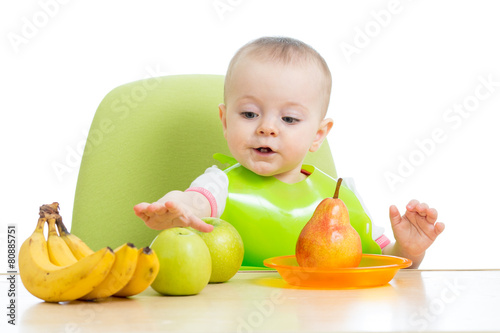 baby sitting at table with ...