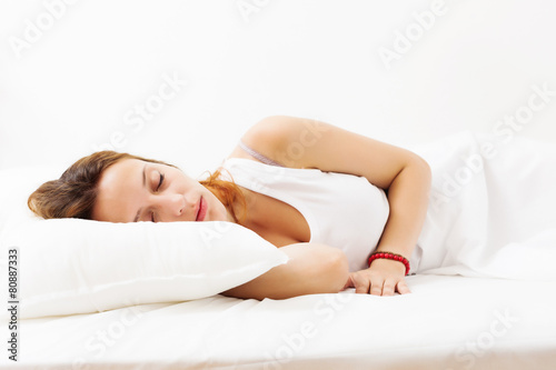  Pretty girl in shirt sleeping on white