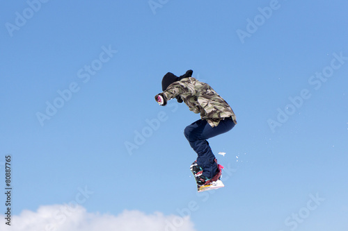 Snowboarder jumps in Snow Park