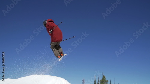 Slow Motion Man Skiing Doing Spin Off Jump  photo