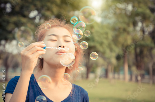 young woman play blowing bubble outdoor lifestyle vintage color
