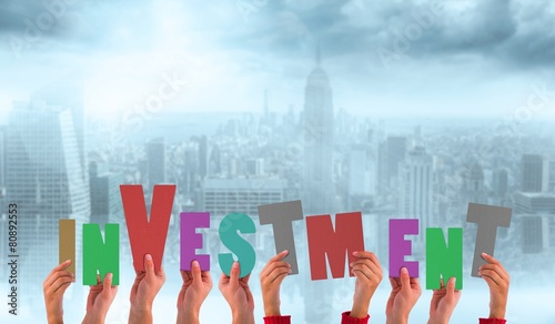 Composite image of hands showing investment