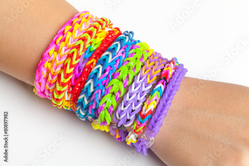 Colorful rubber rainbow loom band bracelets on hand