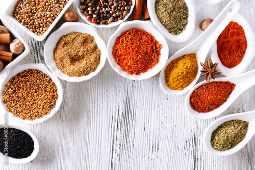 Fototapeta Naklejka Na Ścianę i Meble -  Different kinds of spices in ceramics bowls and spoons