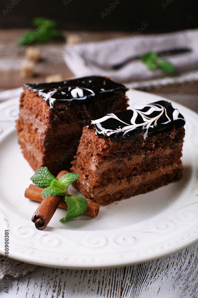 Tasty pieces of chocolate cake with mint and cinnamon Tasty pieces of chocolate cake with mint and cinnamon