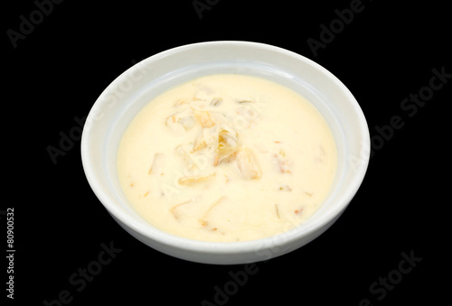 Bowl of clam chowder on a black background