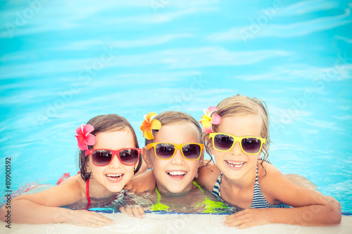 Happy children in the swimming pool © Sunny studio