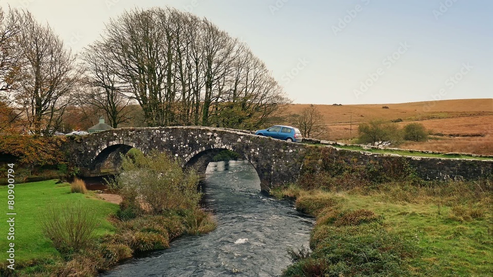 Car Passes Over River On Old Stone Bridge Car Passes Over River On Old Stone Bridge