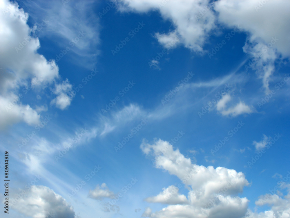 Blue sky with fleecy and cumulus clouds