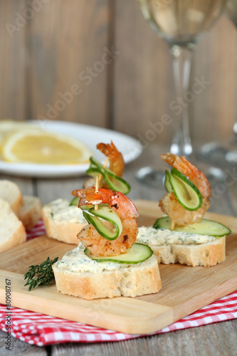 Appetizer canape with shrimp and cucumber on table close up