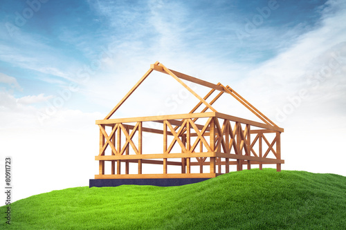 wooden framing for construction of new house on grass on sky bac