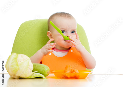 baby sitting at table with ...