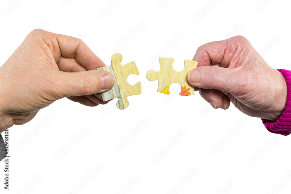Two hands uniting fitting puzzle pieces Two hands uniting fitting puzzle pieces