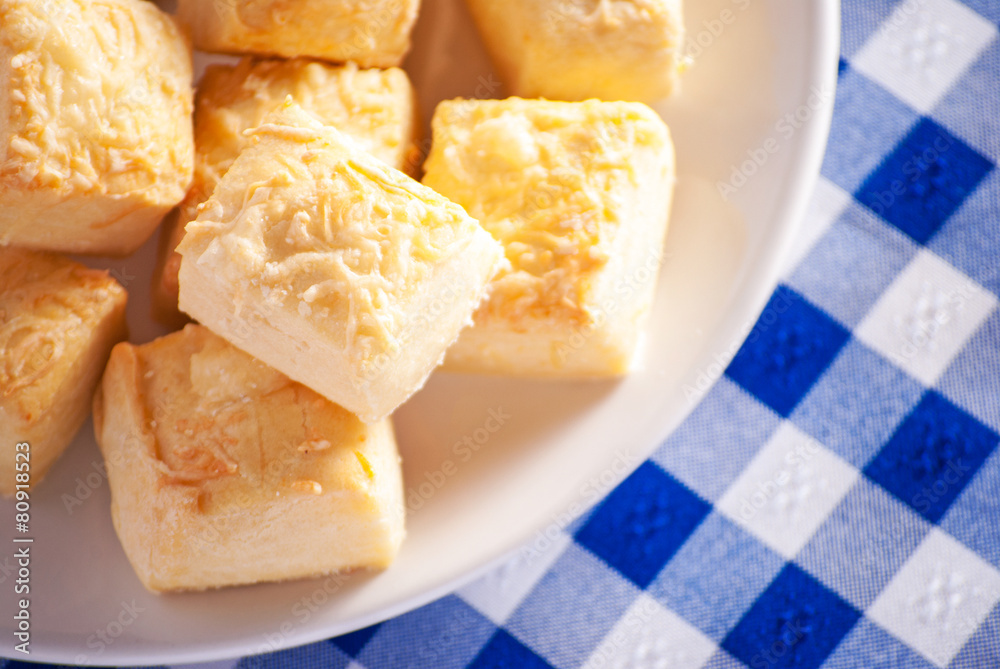 Cheese scones close up on blue checkered tablecloth Cheese scones close up on blue checkered tablecloth