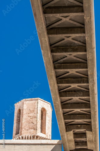 Pedestrian bridge viewed from below against blue sky photo